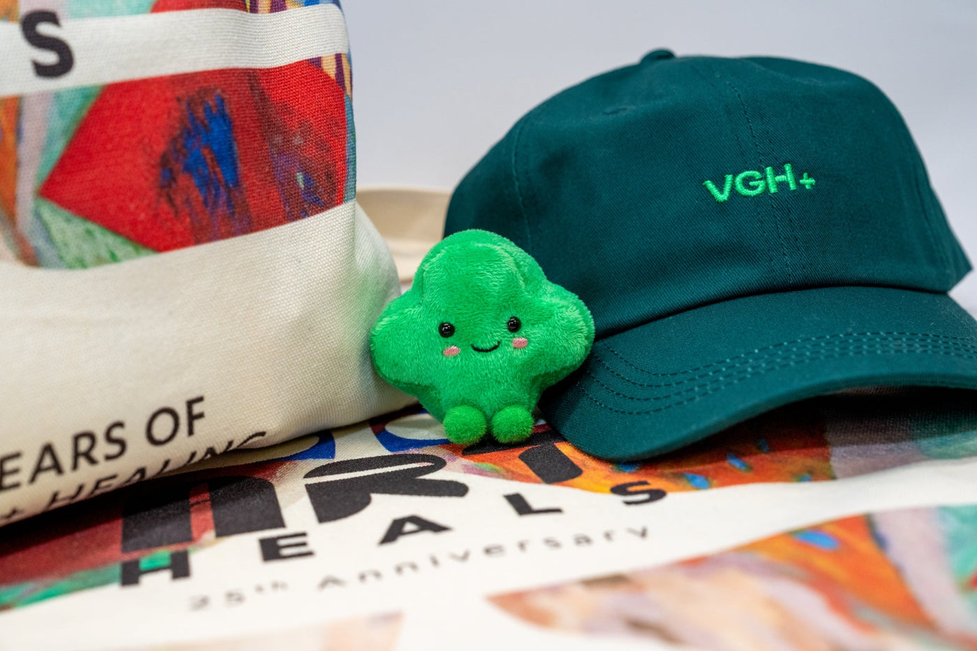 Collection of VGH+ Merchandise: Green VGH+ Hat, Green VGH+ PLUSh, VGH+ Tote Bag
